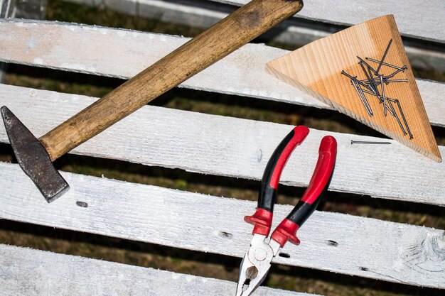 Tools needed to build a Chicken Coop: hammer, screwdriver, saw, measuring tape, and safety glasses.