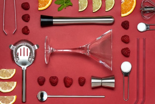 A close-up of various bar tools and drink ingredients arranged neatly on a countertop. Featured items include a cocktail shaker, jigger, muddler, various bottles of spirits, fresh citrus fruits, and garnishes, showcasing the essential elements for crafting cocktails at a DIY home bar.