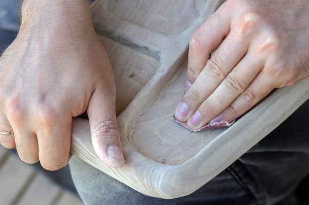 A close-up of a wooden headboard being crafted, showing the hands of a person carefully sanding down the edges to ensure a smooth finish. The workshop background includes various tools and materials, highlighting the DIY process.