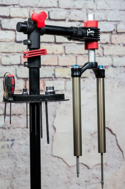A close-up of a wall-mounted bike repair stand, showing the mounting mechanism and how it folds away when not in use.
