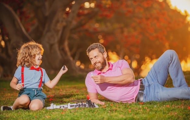 A father and daughter are sitting on hill looking at an city.