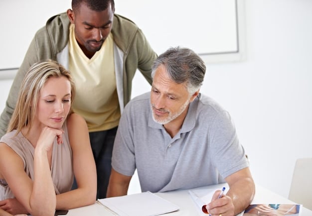 A family sitting at a table, reviewing a financial aid application form and discussing college options with a financial advisor.