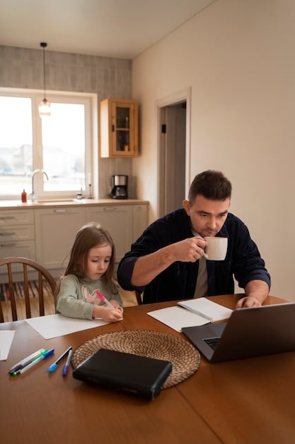 A single father sitting at a table with his child, reviewing mortgage documents and using a calculator.