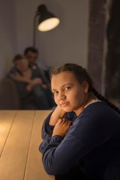 A child looking sad and withdrawn, sitting alone while two adults argue in the background, partially blurred.