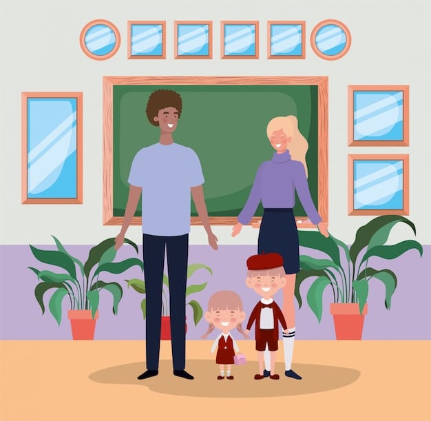 A classroom setting with a teacher talking to two parents, one male and one female, sitting side by side in small chairs. The parents are listening attentively and making notes, displaying active participation in their child's education. The lighting is soft.