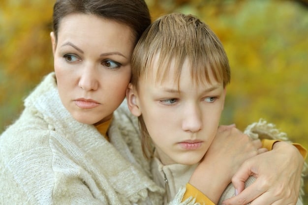 A parent hugging their child tightly, with the child looking sad and overwhelmed. The background is blurred, but suggests a tense environment, implying the presence of a narcissistic co-parent.