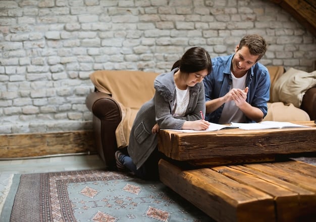 Two parents sitting across from each other at a neutral table, looking at each other and talking calmly with a notepad and pen in front of them.