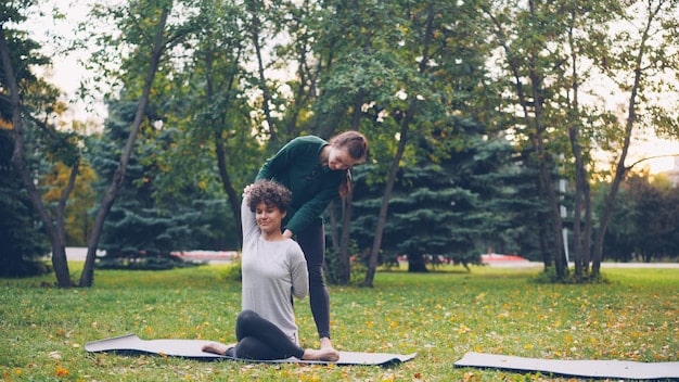 A serene single father practices yoga outdoors at sunrise, with a tranquil landscape in the background, signifying a focus on physical and mental health.