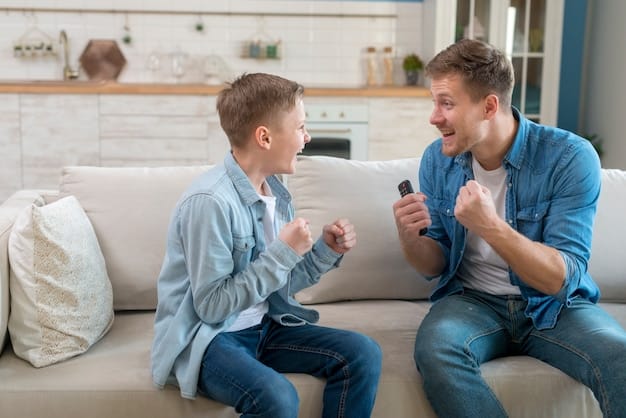 A father is having a conversation with his son. Both are making eye contact.