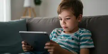 Child engaged with tablet, illustrating screen time's influence on young development