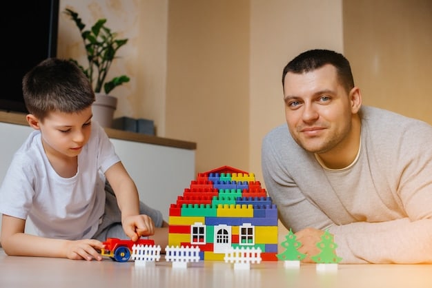 A single father and his child, about 7 years old, collaboratively building a complex LEGO structure on a living room floor. Both are smiling and focused on the task, surrounded by colorful LEGO bricks. The scene is warm and shows shared concentration and joy.